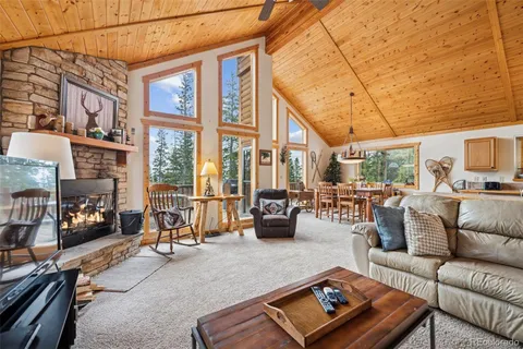 a living room with furniture a fireplace and next to a window
