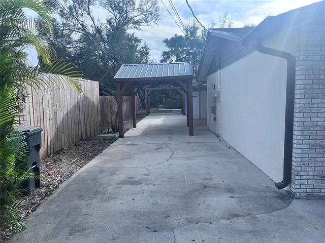 a view of house with backyard and trees