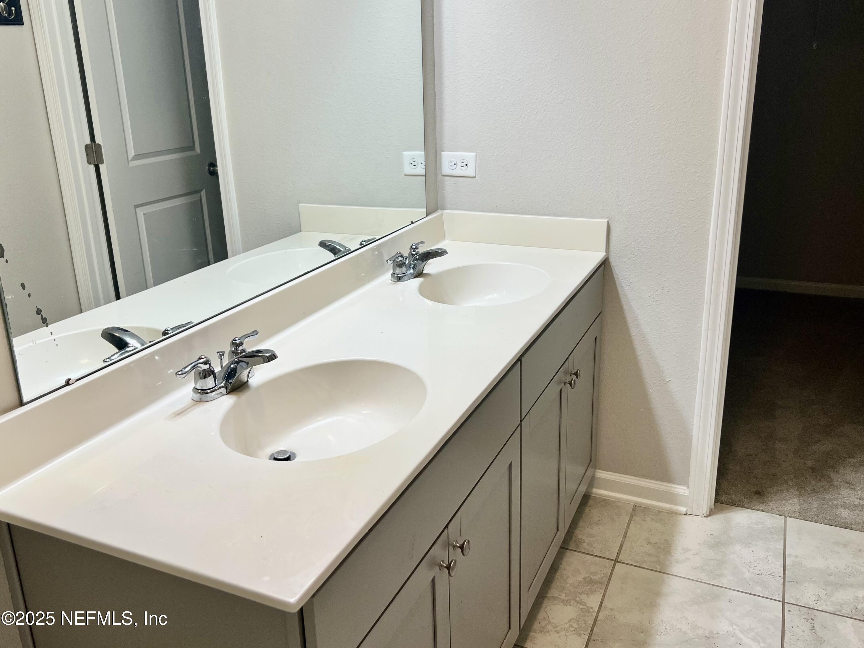 11630 Palladio Way Jacksonville, FL 32218 - Photo 13 of 23 a bathroom with a sink and a mirror