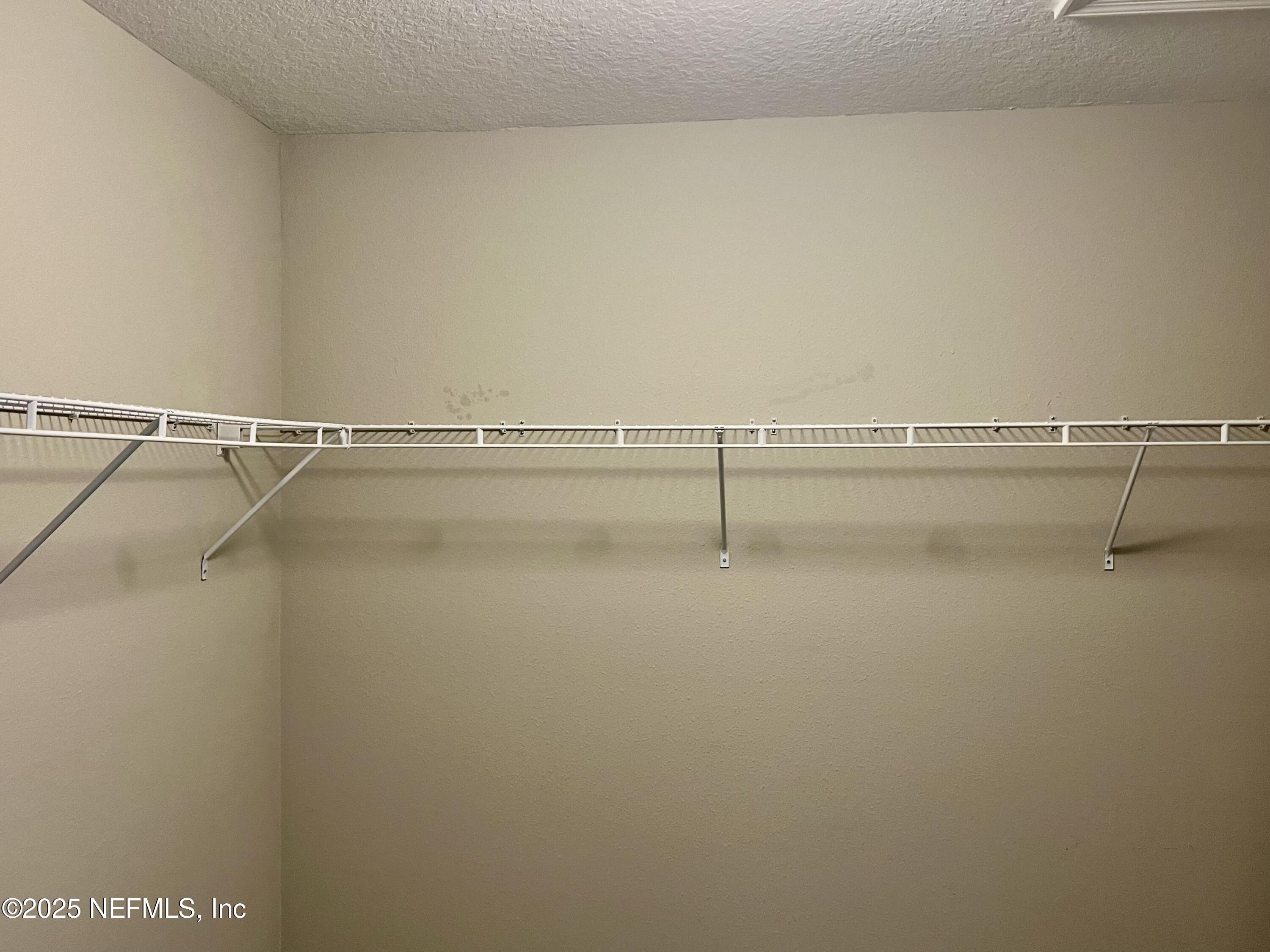 11630 Palladio Way Jacksonville, FL 32218 - Photo 14 of 23 a view of a room with racks on the wall