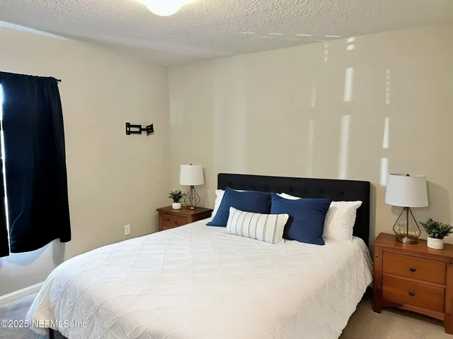 a bedroom with a bed and a lamp