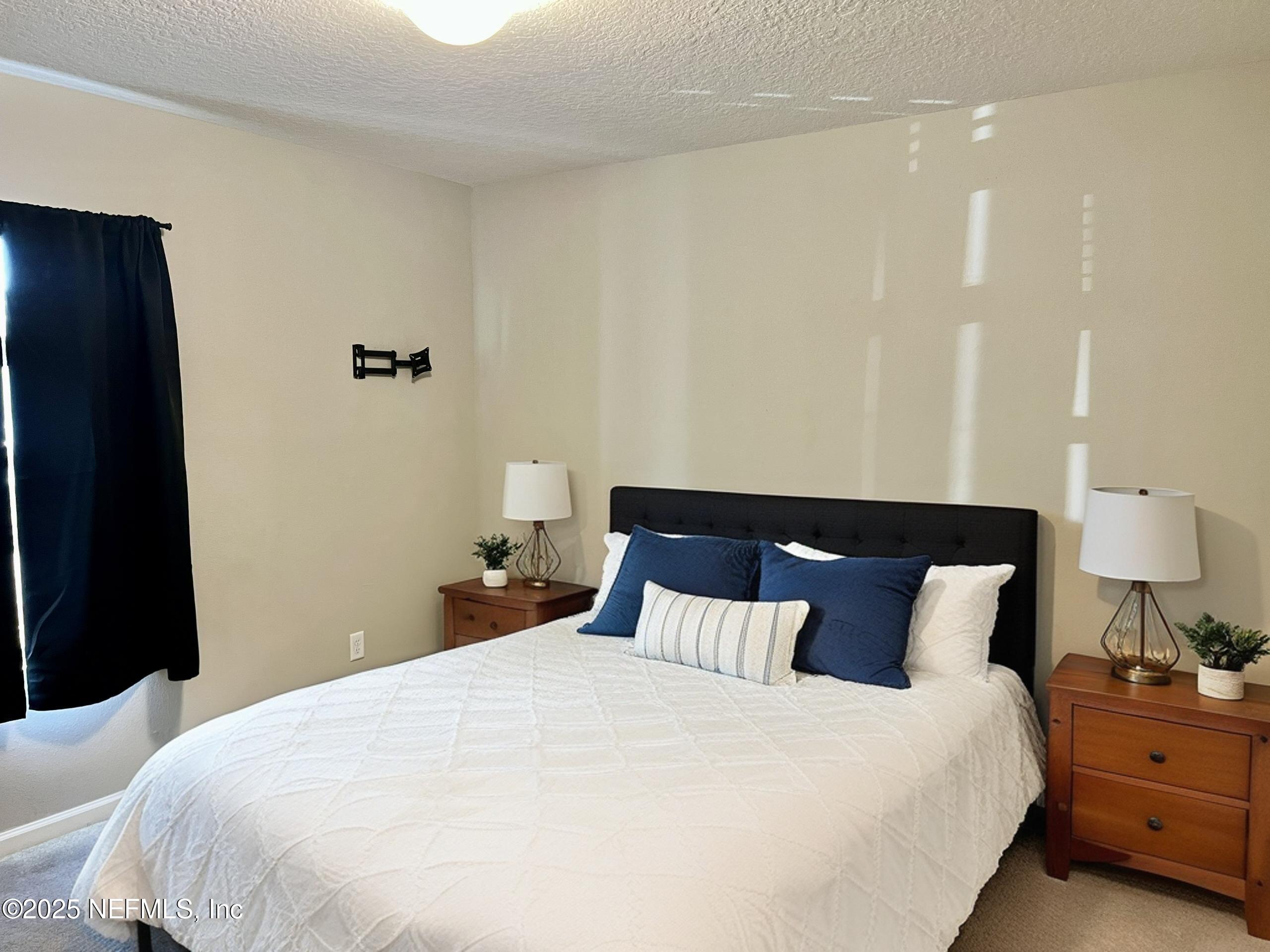 11630 Palladio Way Jacksonville, FL 32218 - Photo 15 of 23 a bedroom with a bed and a lamp