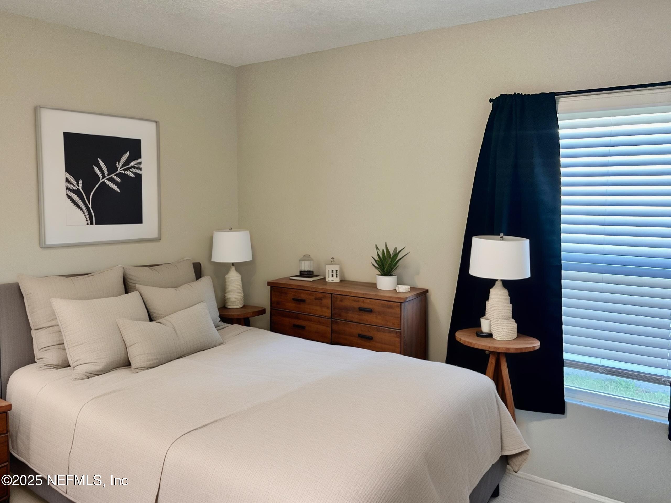 11630 Palladio Way Jacksonville, FL 32218 - Photo 16 of 23 a bedroom with a bed and a lamp on table