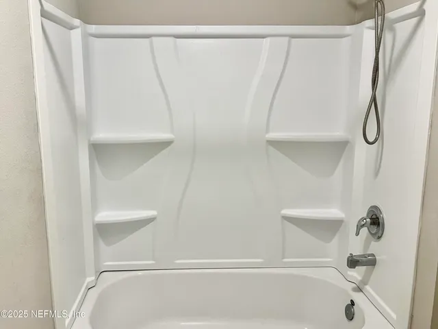 a bathroom with a shower and a bath tub