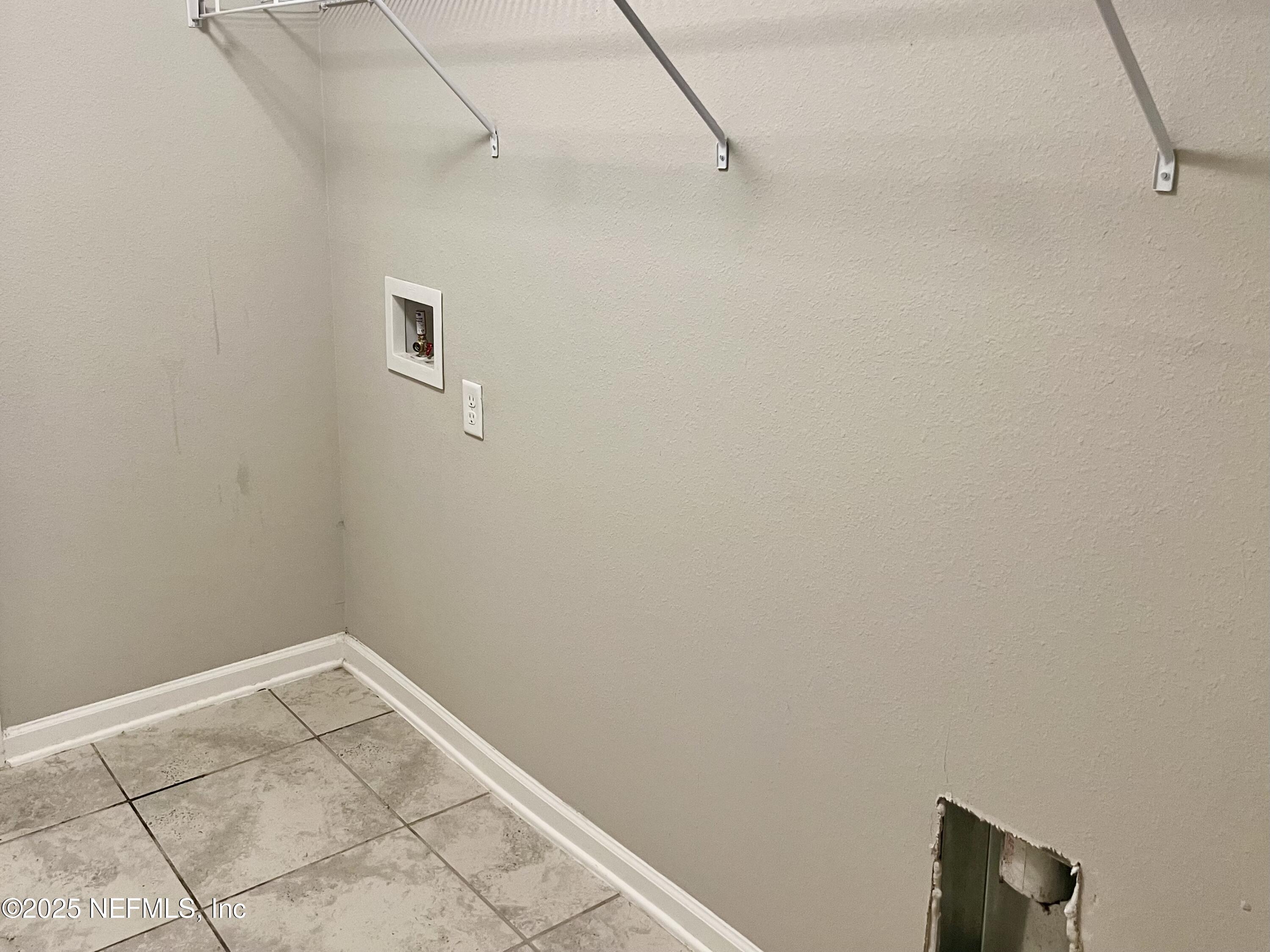 11630 Palladio Way Jacksonville, FL 32218 - Photo 19 of 23 a view of a room with racks on the wall