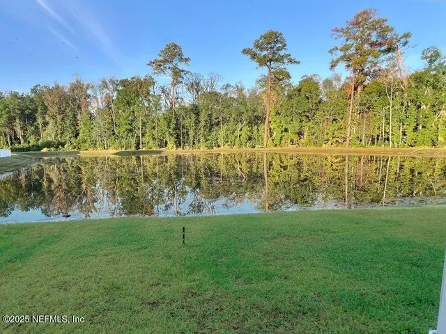 a view of a lake with a yard