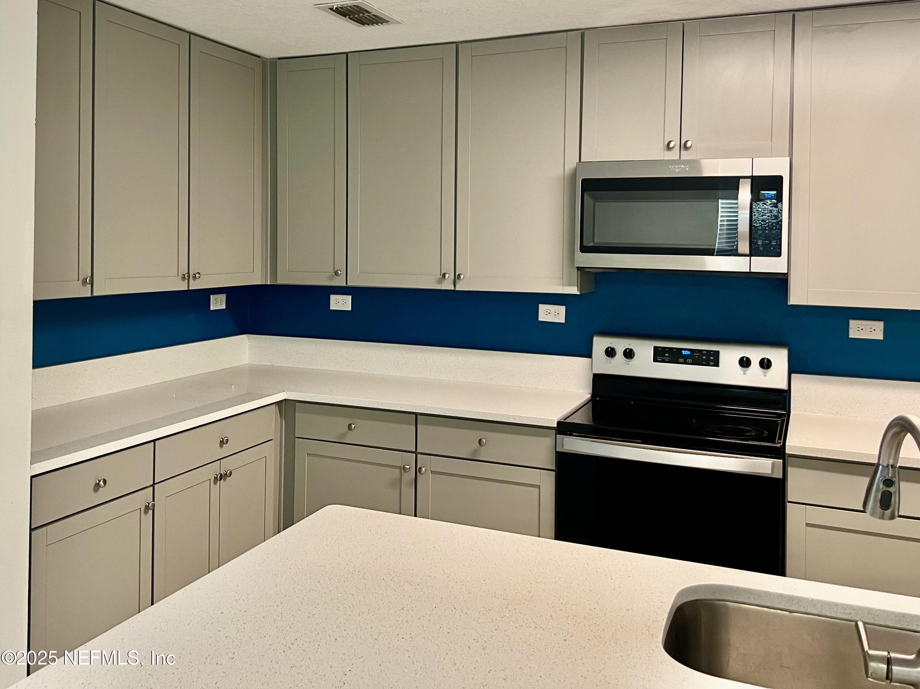 11630 Palladio Way Jacksonville, FL 32218 - Photo 5 of 23 a kitchen with granite countertop cabinets stainless steel appliances and wooden cabinets