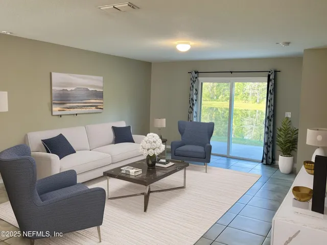 a living room with furniture and a large window