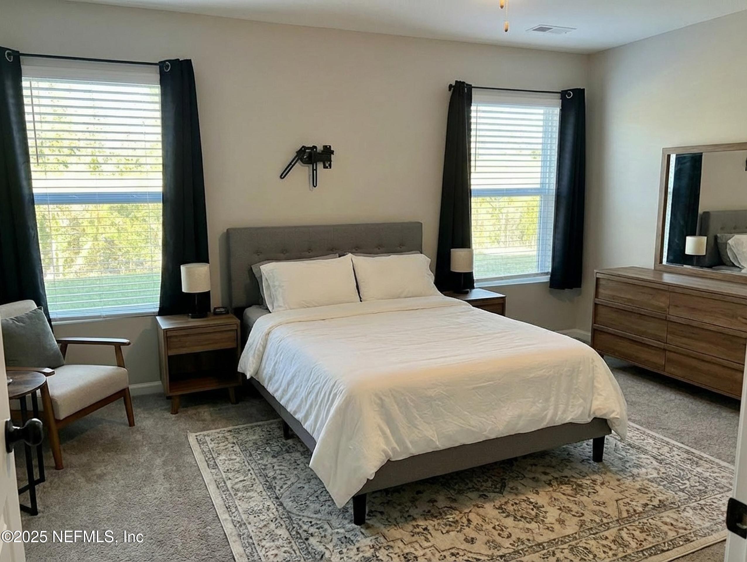 11630 Palladio Way Jacksonville, FL 32218 - Photo 10 of 23 a bedroom with a bed chair and window