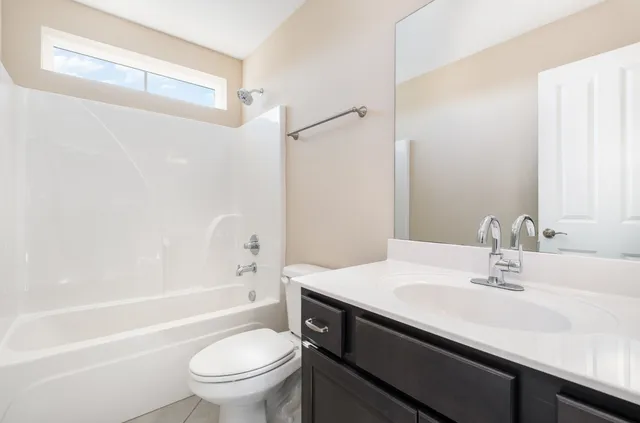 a bathroom with a sink a toilet and a bathtub