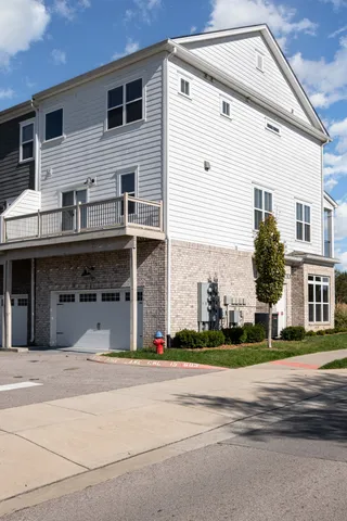 a front view of a house with a road