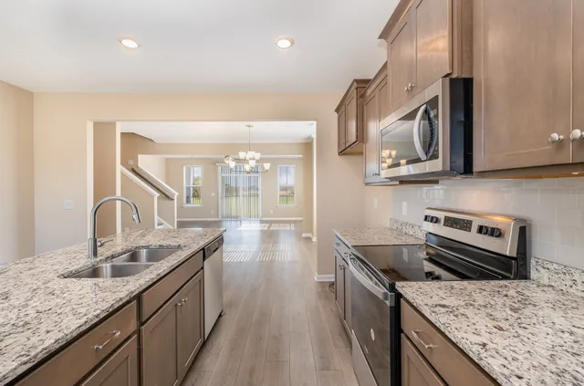 a kitchen with a stove sink and microwave