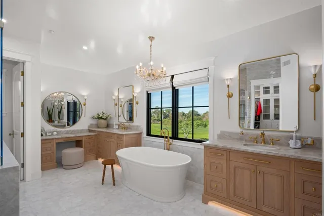 a bathroom with a toilet a sink a tub and mirror