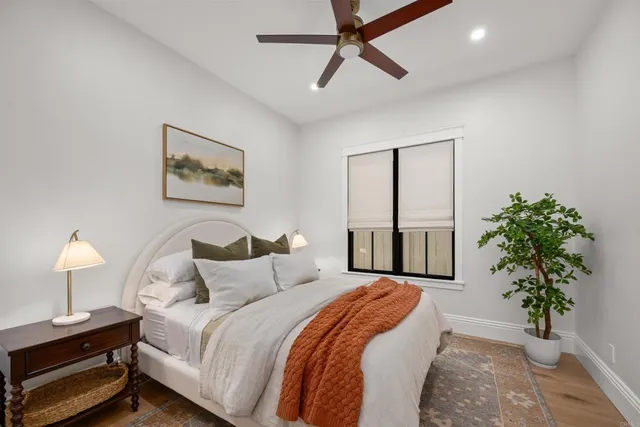 a bedroom with a bed and a potted plant