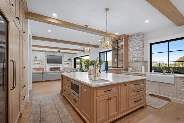a large white kitchen with a large window