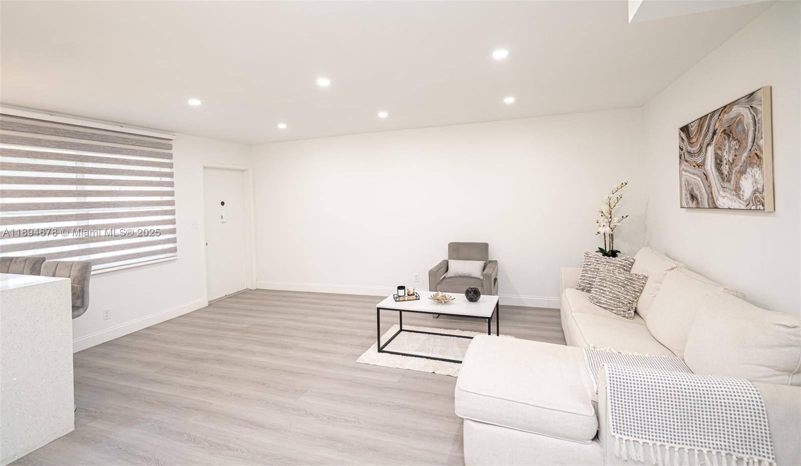 5300 Washington Street, Unit T227 Hollywood, FL 33021 - Photo 16 of 45 a living room with furniture and a wooden floor