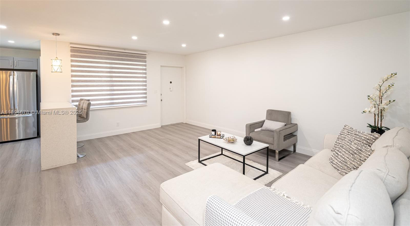 5300 Washington Street, Unit T227 Hollywood, FL 33021 - Photo 17 of 45 a living room with furniture and a wooden floor