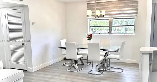 a view of a room with furniture wooden floor and windows