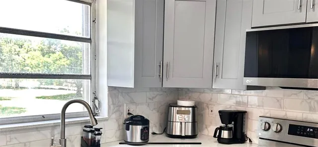 a close view of a sink and a window in a kitchen
