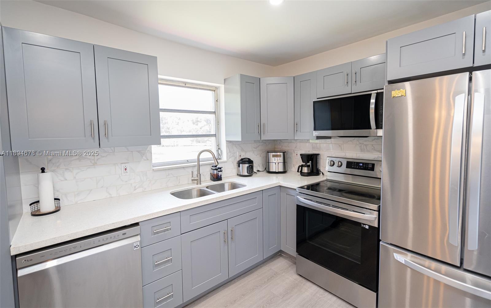 5300 Washington Street, Unit T227 Hollywood, FL 33021 - Photo 25 of 45 a kitchen with cabinets stainless steel appliances a sink and window