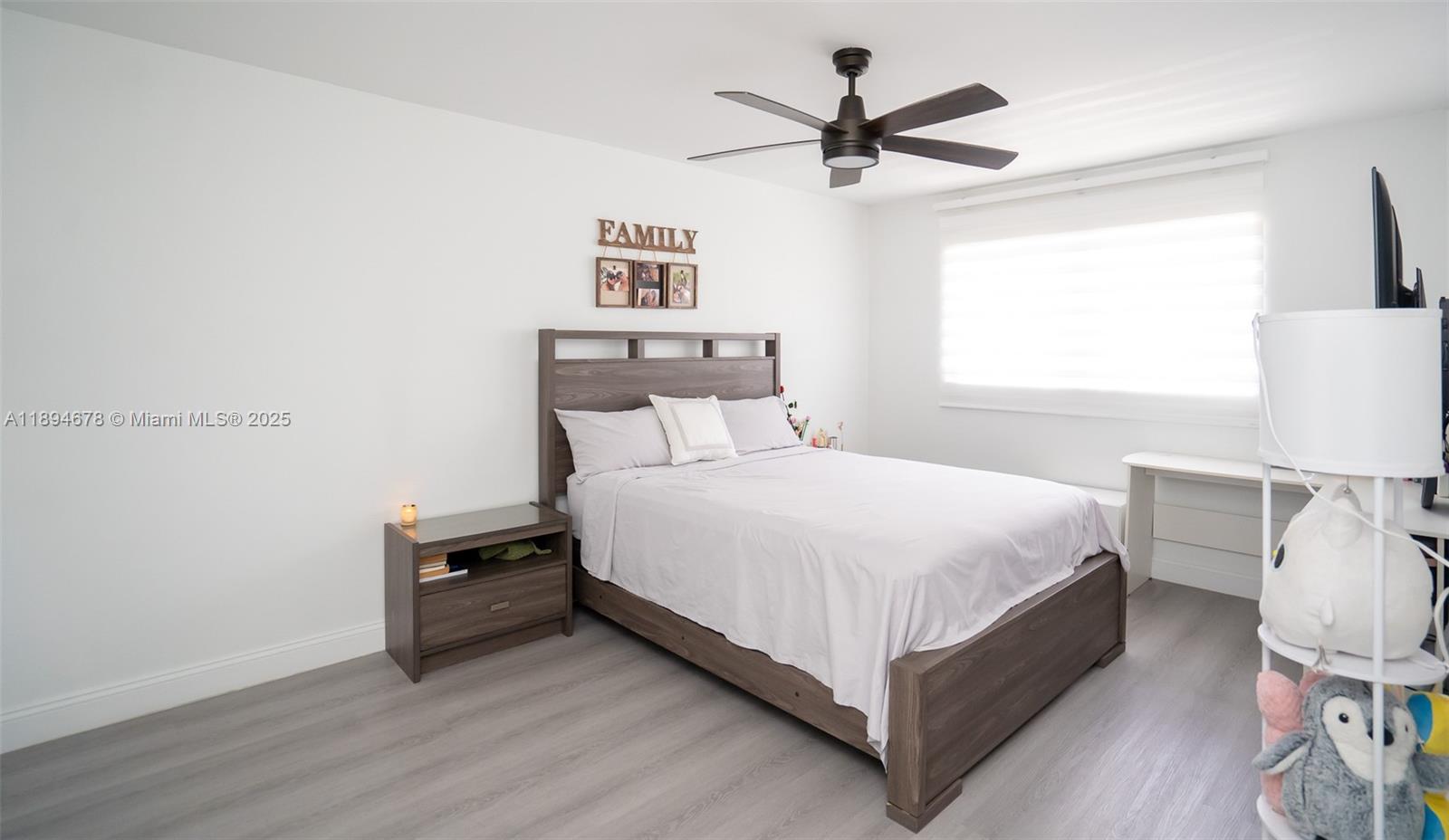 5300 Washington Street, Unit T227 Hollywood, FL 33021 - Photo 30 of 45 a bedroom with a bed a window and a potted plant on the dresser