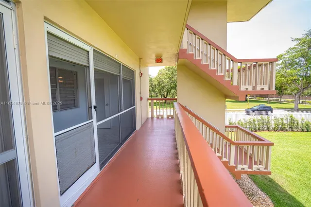 a view of a balcony with wooden floor