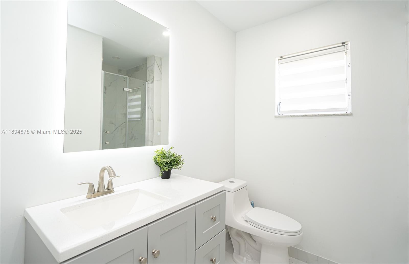 5300 Washington Street, Unit T227 Hollywood, FL 33021 - Photo 33 of 45 a bathroom with a sink vanity mirror and toilet