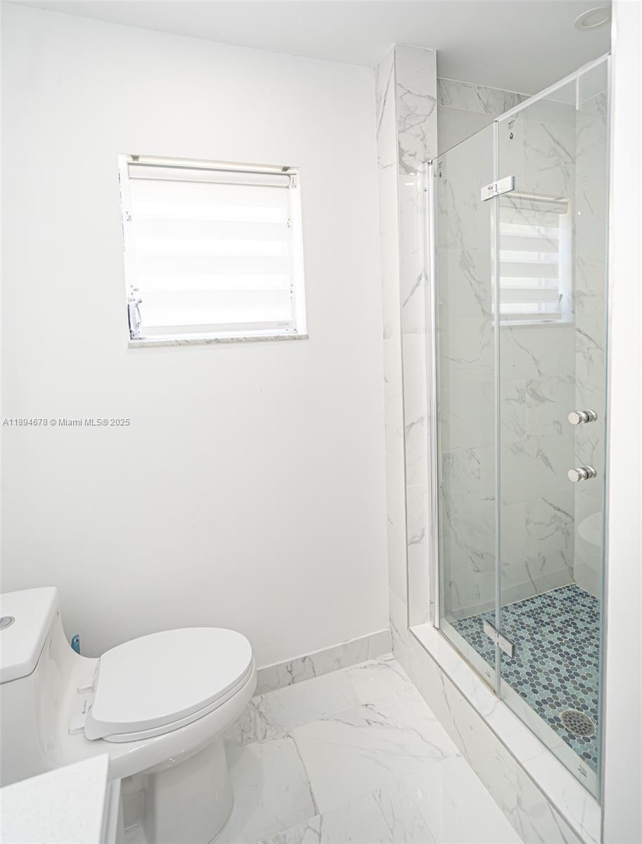 5300 Washington Street, Unit T227 Hollywood, FL 33021 - Photo 35 of 45 a white toilet sitting next to a bathroom sink