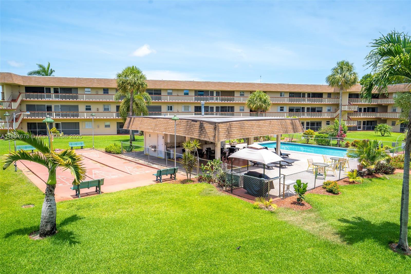 5300 Washington Street, Unit T227 Hollywood, FL 33021 - Photo 37 of 45 a view of a patio with table and chairs potted plants and large tree