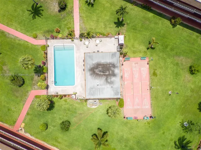 an aerial view of a residential houses with yard