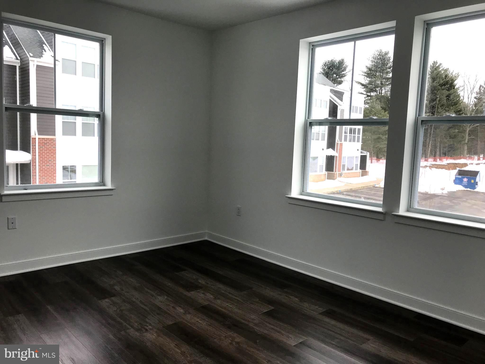 43 Princeton Hightstown Road, Unit 1204 Princeton Junction, NJ 08550 - Photo 2 of 5 a view of a small space with wooden floor and a window