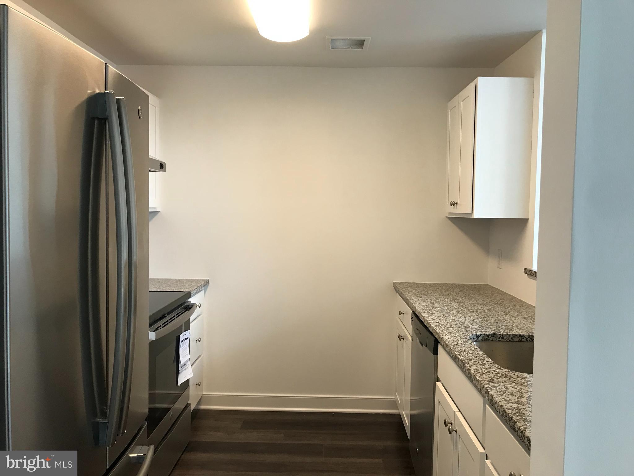 43 Princeton Hightstown Road, Unit 1204 Princeton Junction, NJ 08550 - Photo 5 of 5 a kitchen with a sink and a refrigerator
