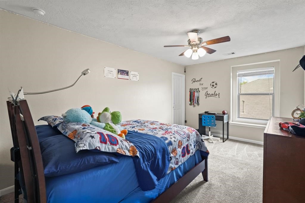 6719 Path Way Court Katy, TX 77449 - Photo 29 of 35 a bedroom with a bed and ceiling fan