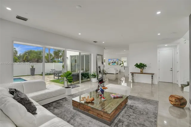 a living room with furniture and a potted plant