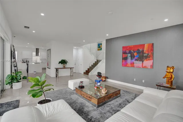 a living room with furniture and a potted plant