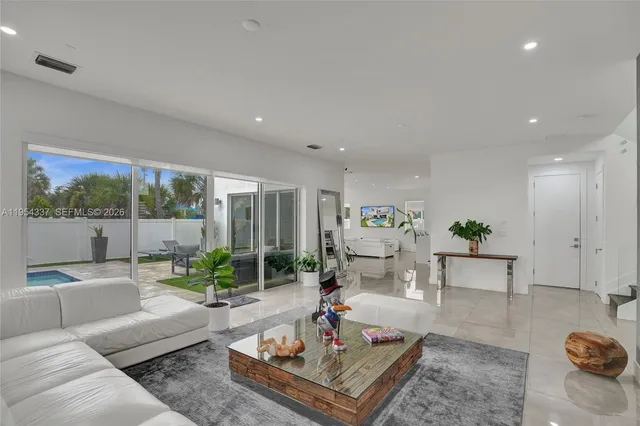 a kitchen with a dining table chairs and white cabinets