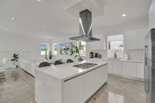 a living room filled with furniture and a potted plant