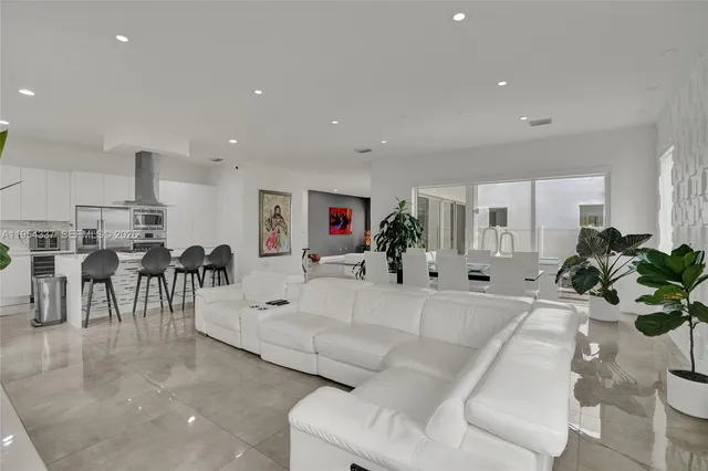 a spacious bedroom with a bed and wooden floor