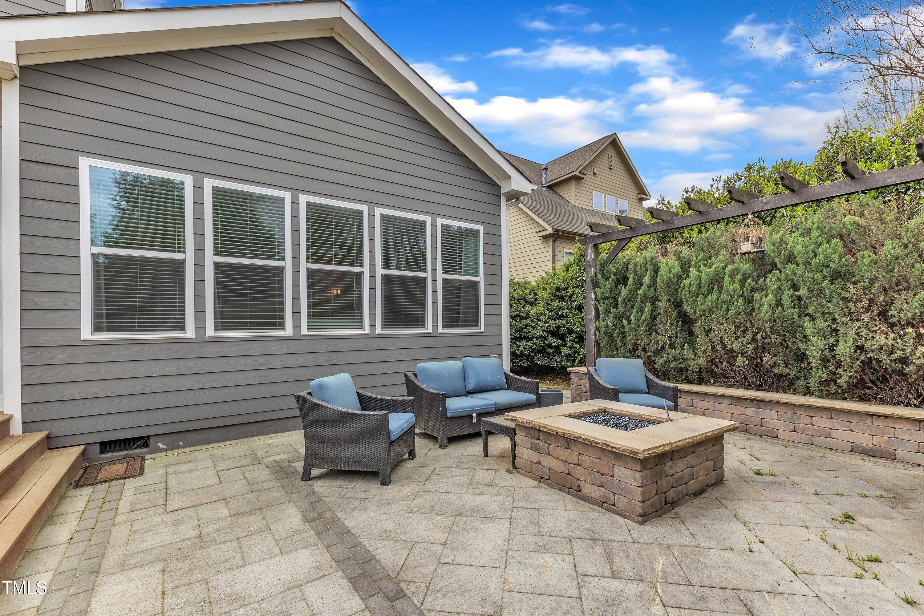 8121 Greys Landing Way Raleigh, NC 27615 - Photo 66 of 95 a building outdoor space with patio furniture and potted plants