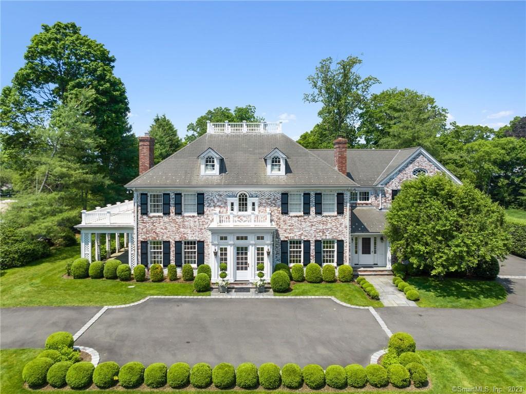 70 Long Neck Point Road Darien, CT 06820 - Photo 1 of 1 a front view of a house with a garden