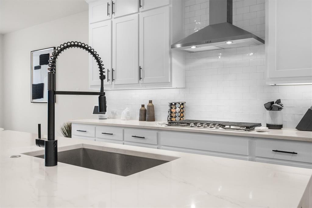 1308 Redbrick Lane Northlake, TX 76247 - Photo 14 of 40 a kitchen with kitchen island a sink stainless steel appliances and cabinets