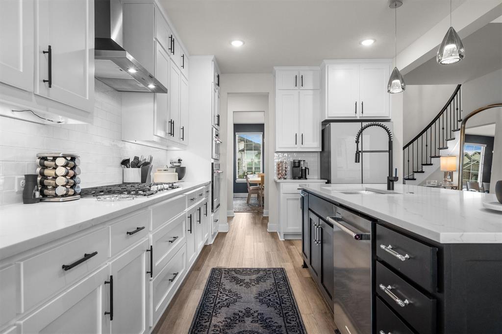 1308 Redbrick Lane Northlake, TX 76247 - Photo 15 of 40 a kitchen with kitchen island granite countertop a sink stainless steel appliances and cabinets