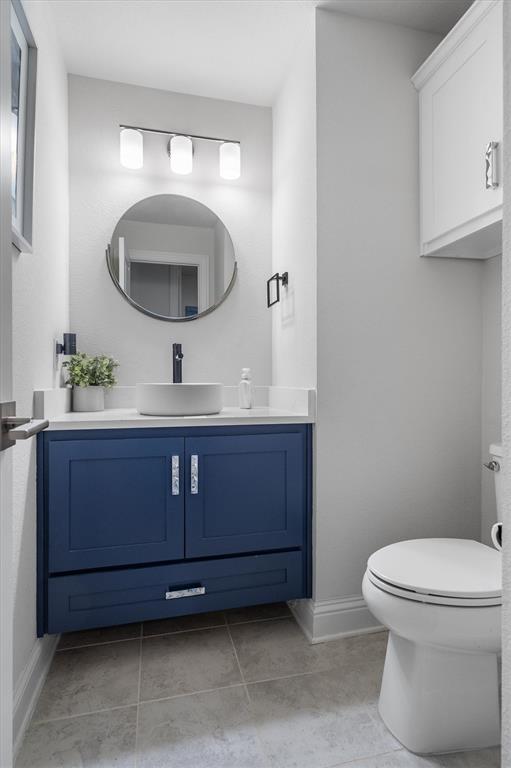 1308 Redbrick Lane Northlake, TX 76247 - Photo 19 of 40 a bathroom with a toilet a sink and mirror