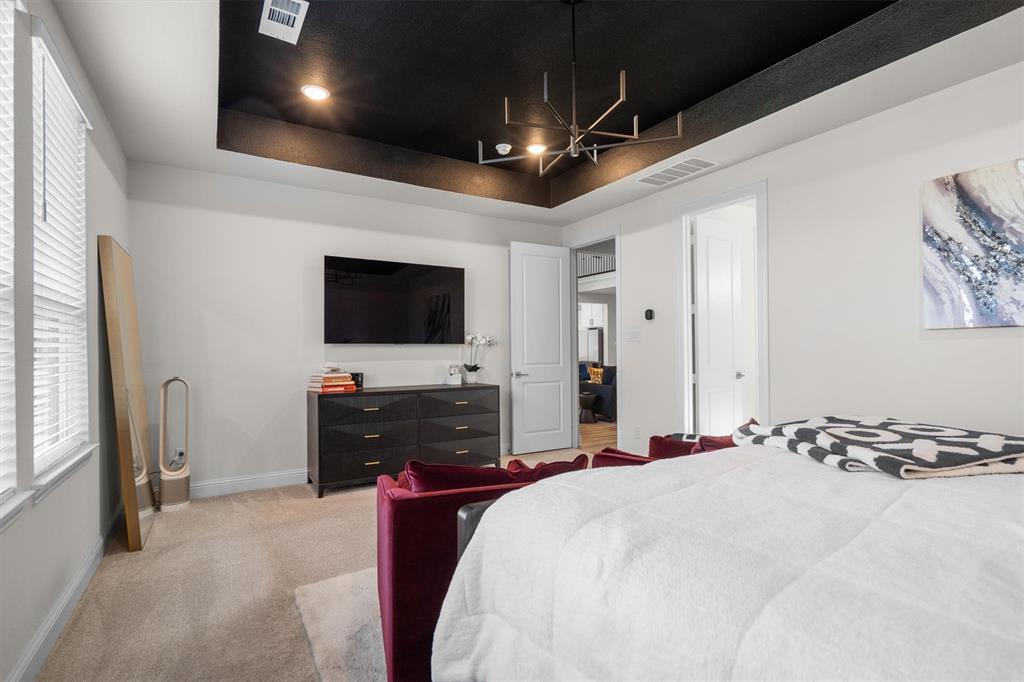 1308 Redbrick Lane Northlake, TX 76247 - Photo 21 of 40 a bedroom with a bed and a flat screen tv