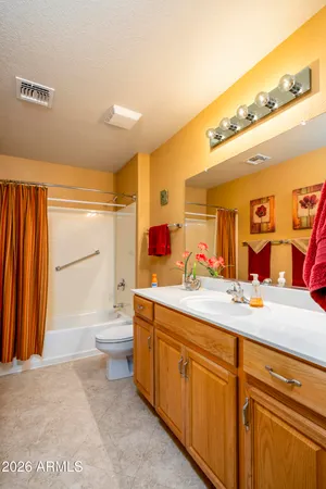 a bathroom with a toilet a sink and a mirror
