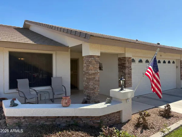 a front view of a house with outdoor seating