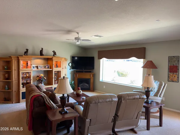a view of a workspace with furniture and a window