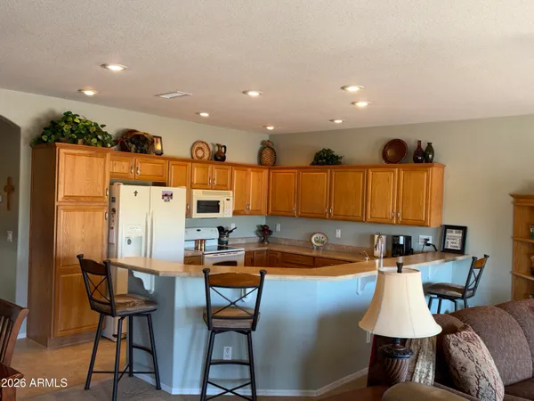 a kitchen with a table chairs sink and cabinets
