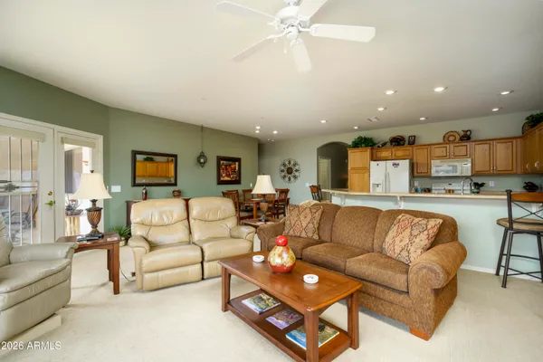 a living room with furniture and kitchen view