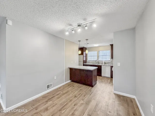 a view of a livingroom with furniture and a flat screen tv